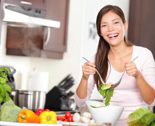 happy woman making salad