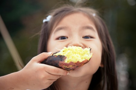 girl eating potato